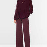 Pleated blouse with feminine details