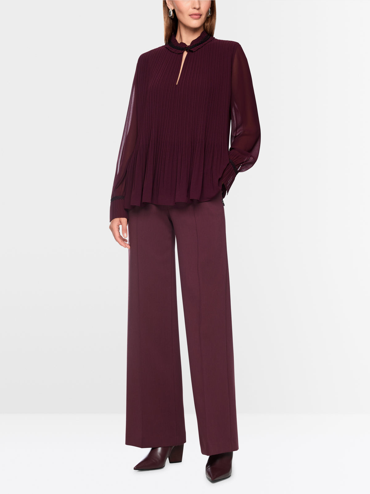 Pleated blouse with feminine details