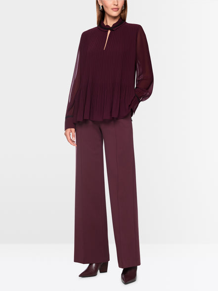 Pleated blouse with feminine details