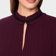 Pleated blouse with feminine details