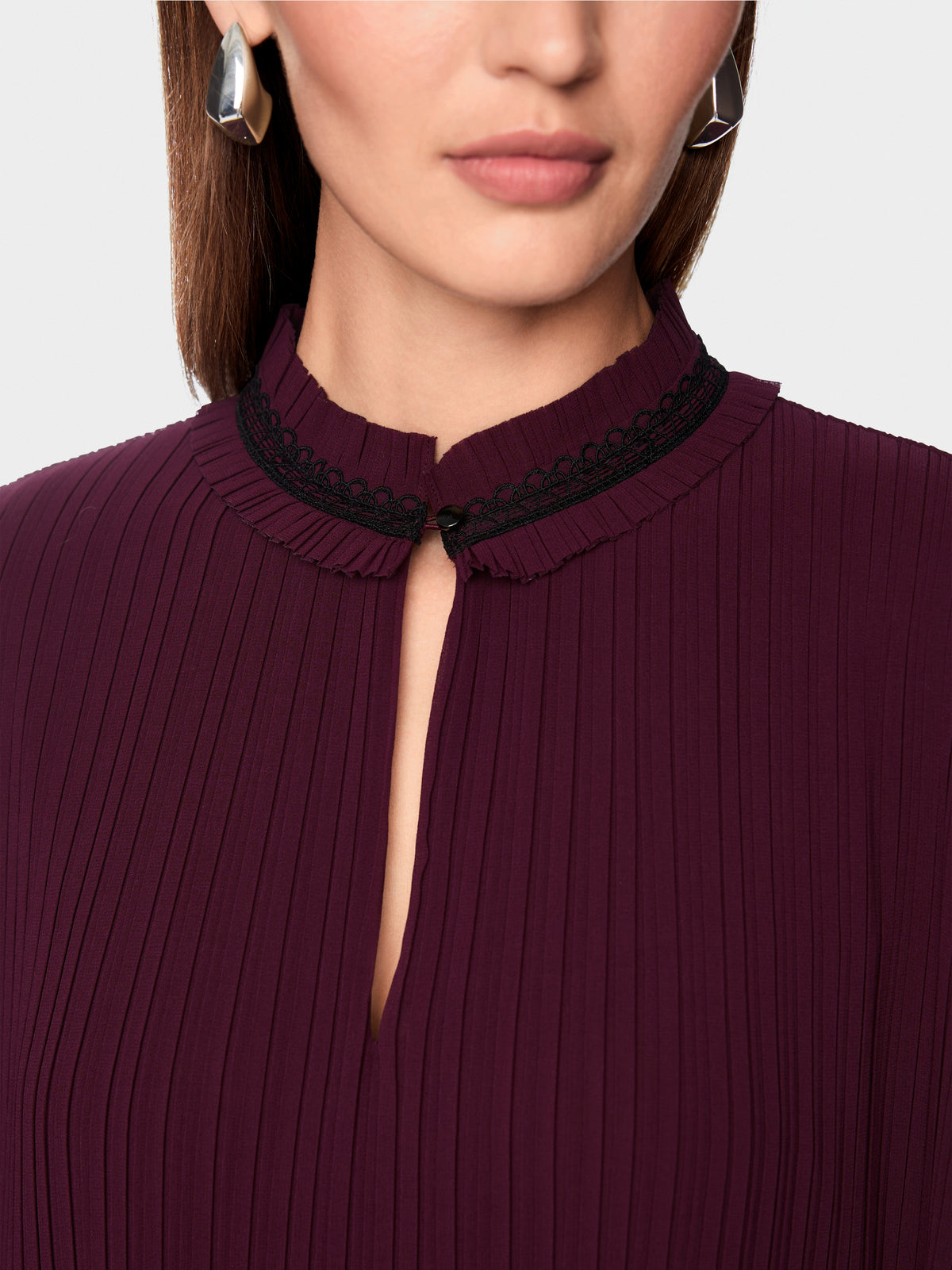 Pleated blouse with feminine details