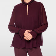 Pleated blouse with feminine details