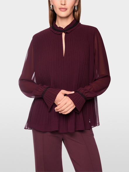 Pleated blouse with feminine details