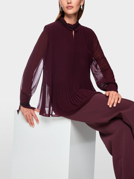 Pleated blouse with feminine details